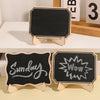 A set of mini wooden chalkboard signs featuring handwritten words like Sunday and Wow
