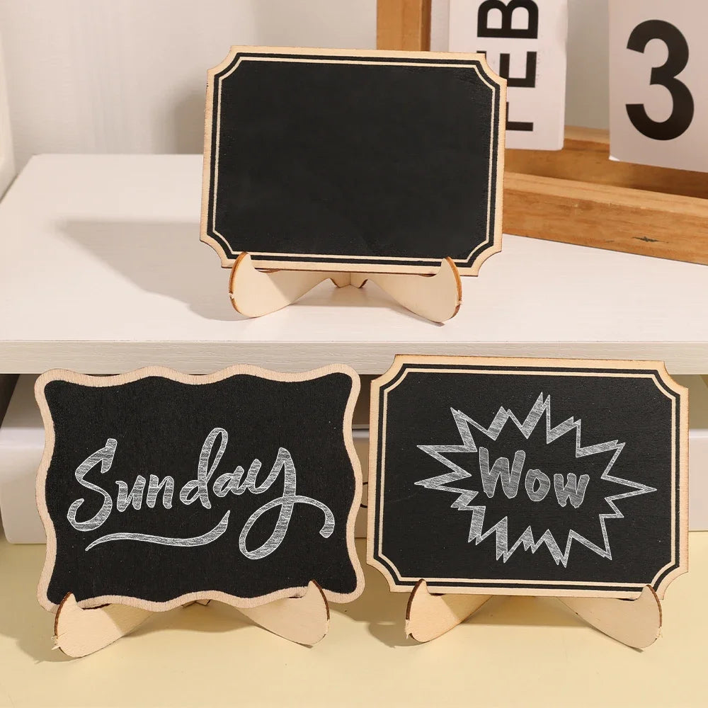 A set of mini wooden chalkboard signs featuring handwritten words like Sunday and Wow