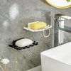 Wall-mounted soap dish with drainage featuring yellow and white bars on a gray marble wall.