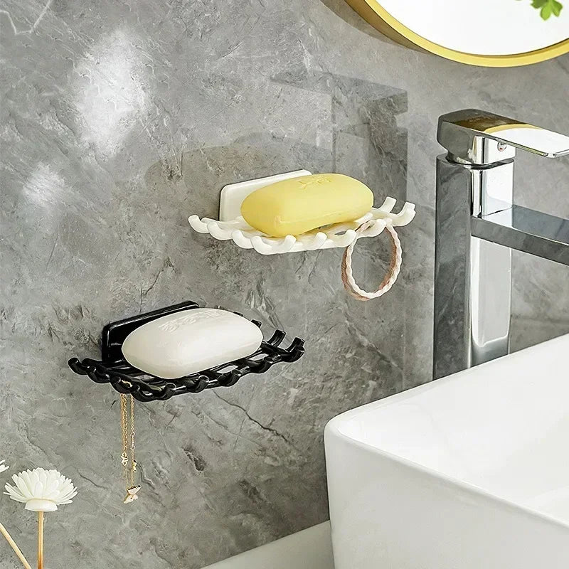 Wall-mounted soap dish with drainage featuring yellow and white bars on a gray marble wall.