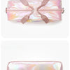 A pink iridescent travel duffel bag with a satin finish and fabric straps.