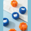 A collection of orange and blue reusable laundry balls used for washing machine cleaning.
