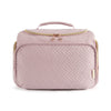 A light pink quilted toiletry bag with a handle and gold zipper details.