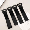 Four black reusable nylon cable ties with adjustable hook and loop fasteners displayed on a white background.