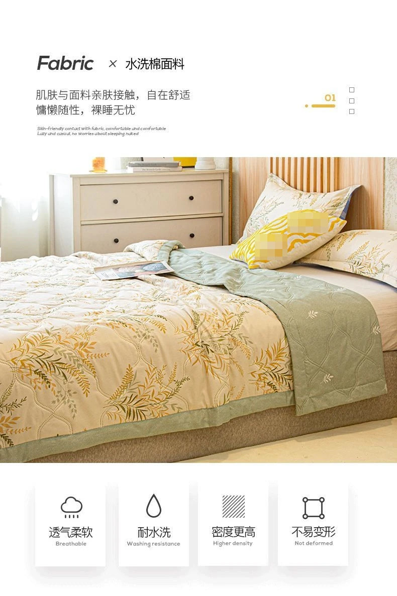 A beige quilted bedspread with gold leaf embroidery is displayed on a bed, emphasizing breathable and durable fabric features