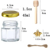 A set of hexagon glass honey jars with wooden dippers and gold lids, including a small wooden dipper and a gold bee charm.