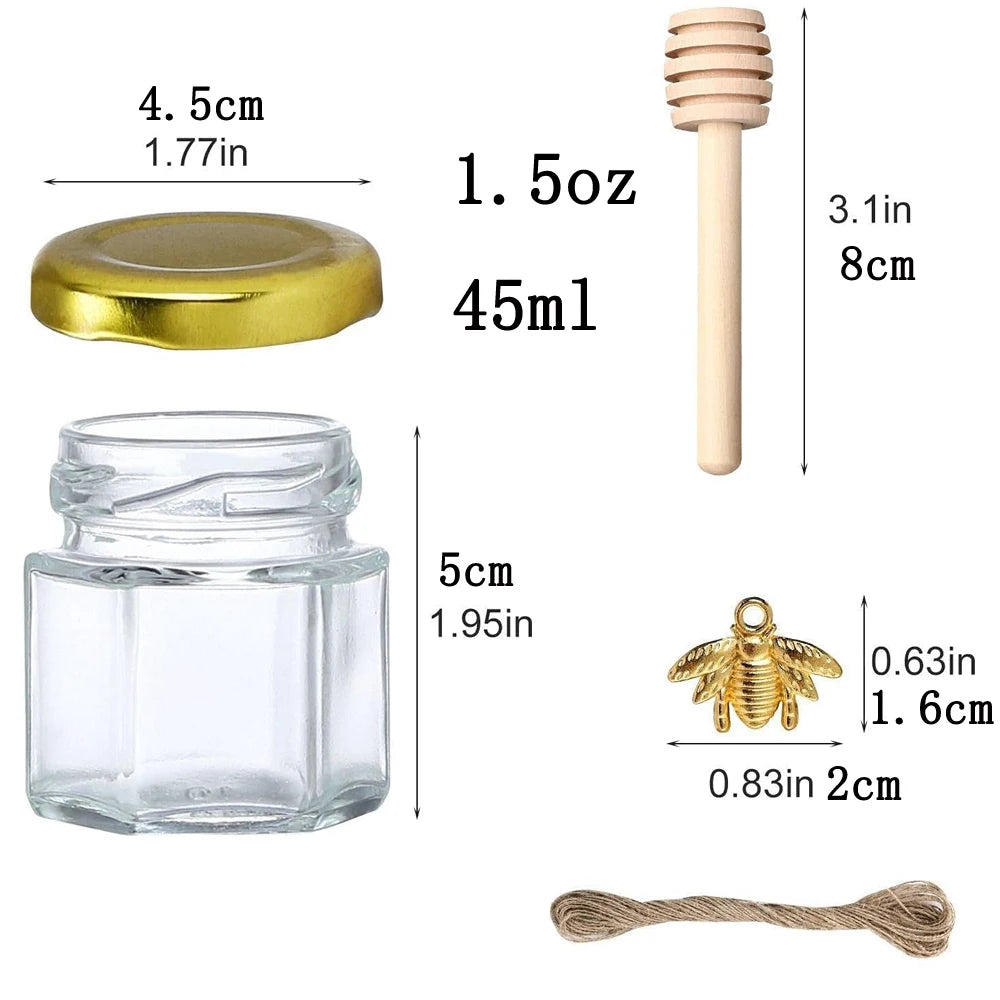 A set of hexagon glass honey jars with wooden dippers and gold lids, including a small wooden dipper and a gold bee charm.