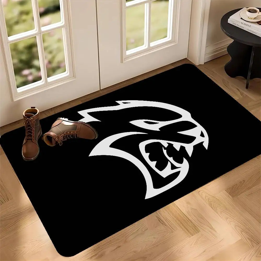Black doormat featuring a white stylized lion head design placed on a wooden floor.
