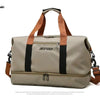 A beige duffle bag with brown straps and black accents shown against a white background.