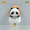 A blind box figure of a panda face with black ears and white fur, mounted on a light beige cylindrical base.