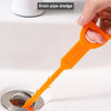 An orange drain pipe dredge tool is shown being used to clear a drain, highlighting its ease of cleaning and strong water fea