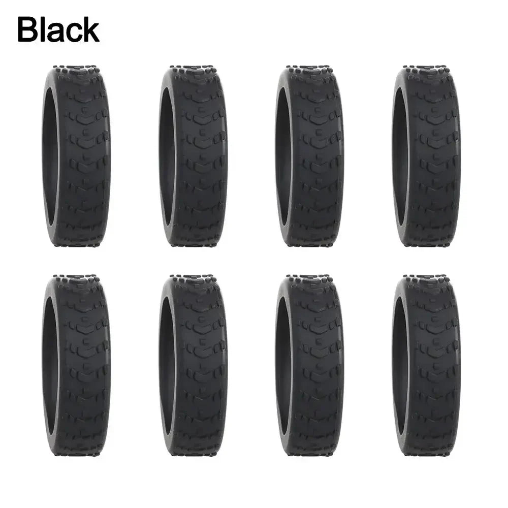 A set of black silicone luggage wheel protectors designed to prevent scratching and reduce noise during travel.