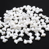 A pile of 100 white acrylic pearl spacer beads for jewelry making