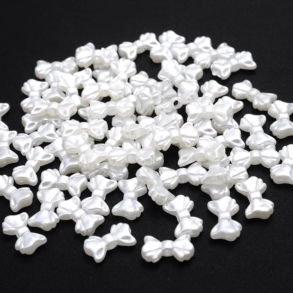 A pile of 100 white acrylic pearl spacer beads for jewelry making