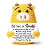 A yellow crochet giraffe doll with a white beard and a card that says Be like a Giraffe