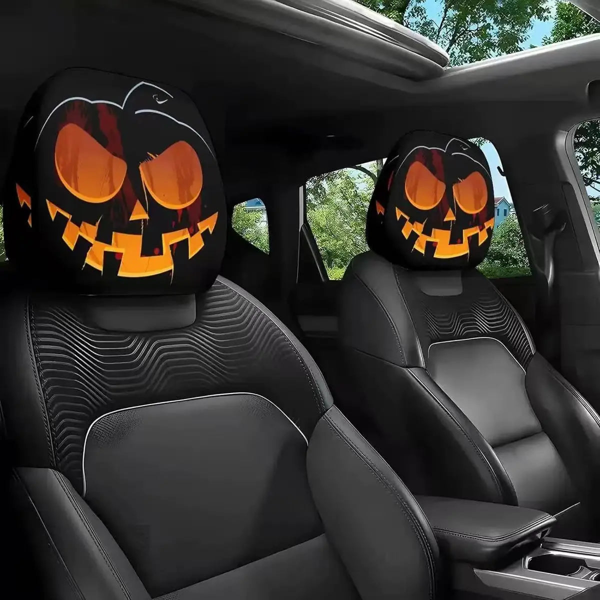 A pair of horror-themed car headrest covers featuring creepy jack-o'-lantern faces installed in a vehicle interior.