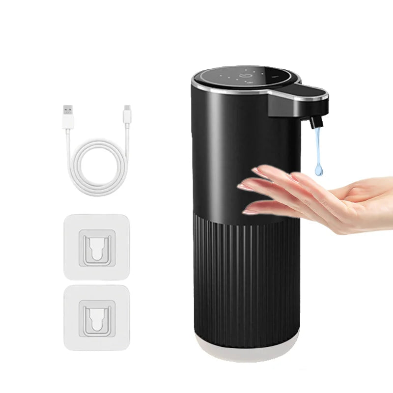 A black touchless automatic soap dispenser with a pump head and USB charging cable shown next to the device.