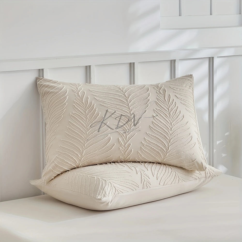 A beige microfiber duvet cover featuring an embossed leaf pattern resting on a white surface.