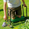 A person is using a heavy duty foldable garden kneeler seat with a tool pouch in a grassy yard.