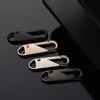 A close-up of five metal zipper slider repair kits in various finishes, including black and brass, displayed against a dark b