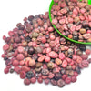 A pile of natural tumbled crystal stone chips in various shades of pink, red, brown, and black stones.