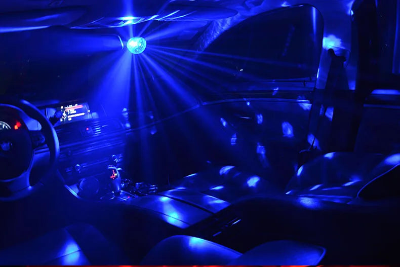Interior view of a car showing bright blue disco light beams illuminating the dashboard and seats.