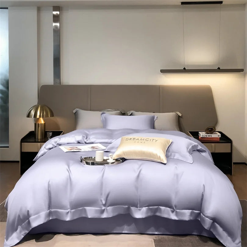 Luxuriöses Bettwäsche-Set mit lavendelfarener Decke und Kissen auf einem modernen Bett.