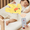 A yellow palm-shaped silicone soothing pillow is placed on a white surface next to a smartphone.