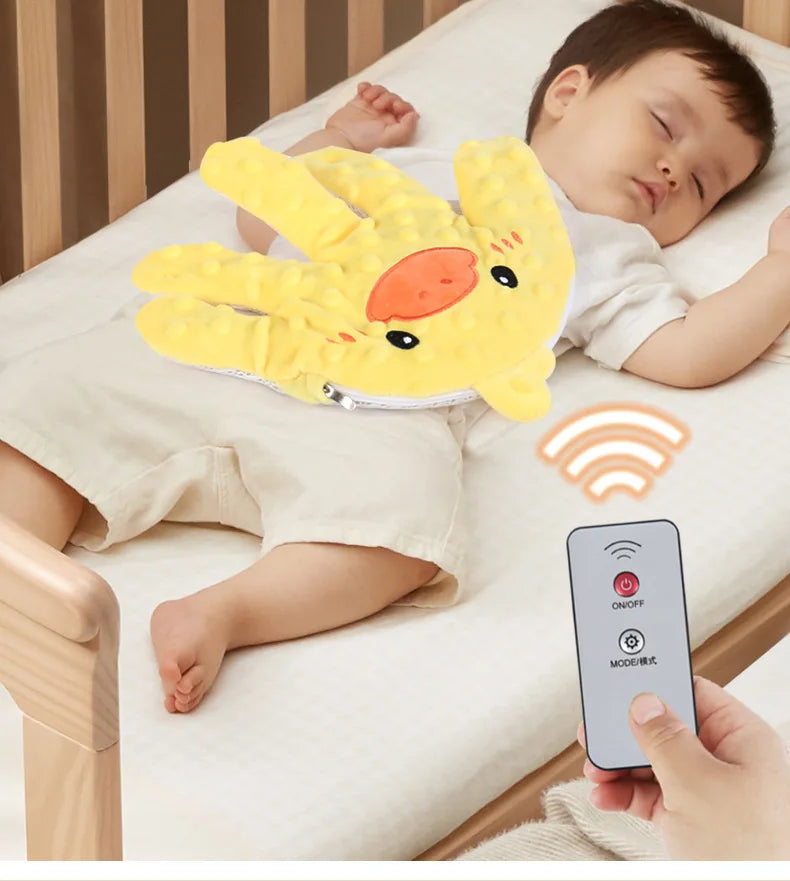 A yellow palm-shaped silicone soothing pillow is placed on a white surface next to a smartphone.