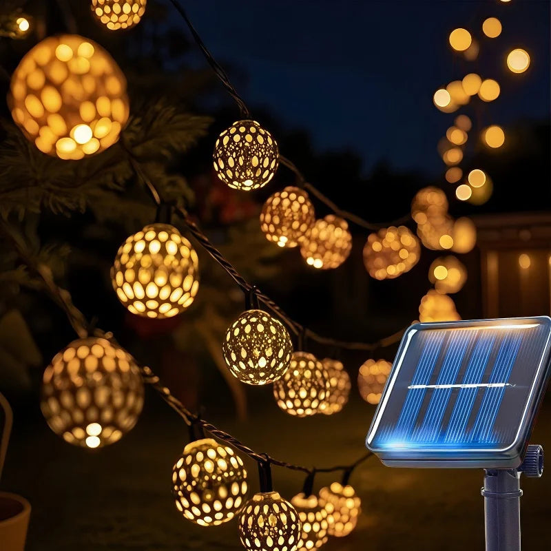 String lights featuring Moroccan-style glowing orbs illuminating an outdoor scene.