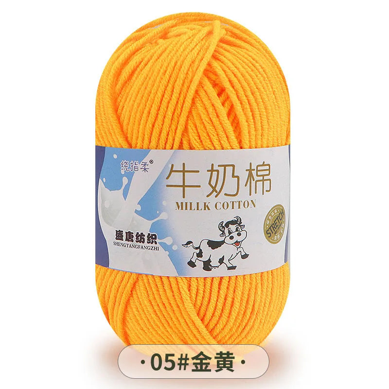 A ball of bright orange milk cotton blend yarn labeled with Chinese characters and a product code.