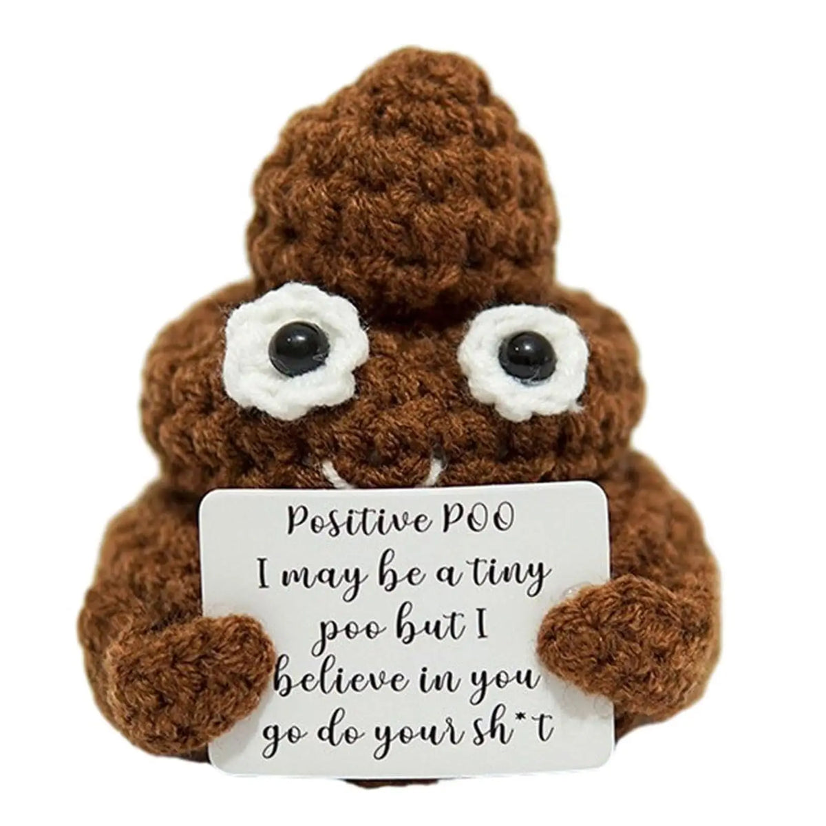 A brown crocheted plush ornament shaped like a creature with large eyes and a white tag that reads Positive POO I may be a ti