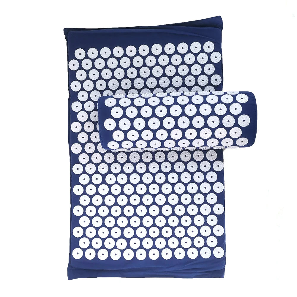 A dark blue acupressure mat and pillow set featuring numerous white, round studs for pain relief.