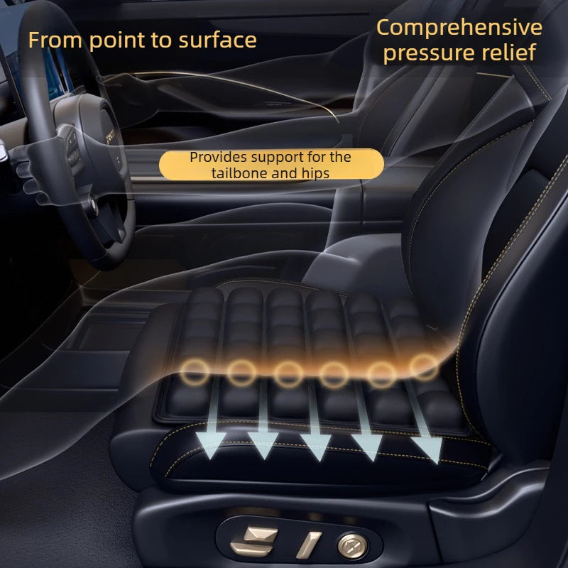 A seat cushion is shown providing pressure relief for the tailbone and hips in a car interior.