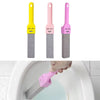 Three colored pumice stone toilet and bathroom cleaning brushes with handles shown next to a hand using one of the pink brush
