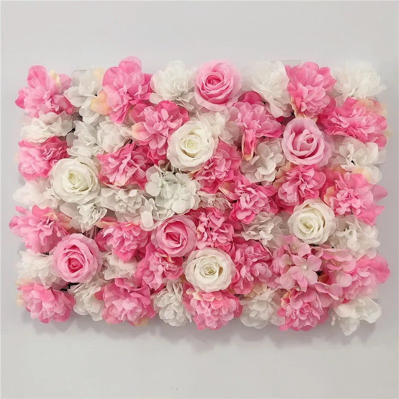 A dense wall panel of pink and white silk rose flowers for weddings and events.