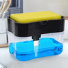 A clear plastic soap dispenser with a black lid and a yellow sponge holder filled with blue liquid.