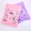 Two pink and purple self-sealing mailing bags featuring a hello cloud bear design
