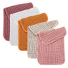 A stack of five colored muslin baby burp cloths in pink, white, orange, and beige.