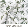 Close-up of white muslin fabric with a green leaf pattern, showing the yarn density.
