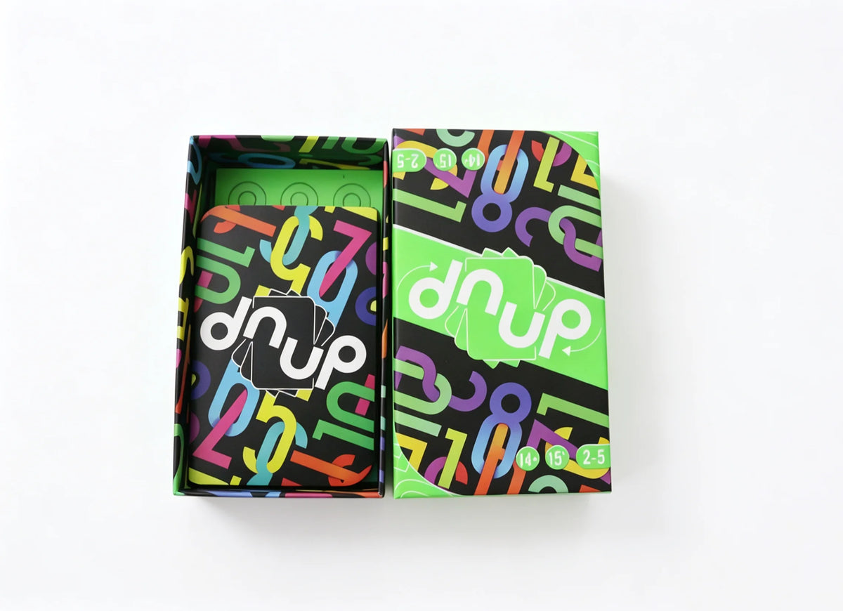 A box of Omega Card Game featuring colorful, abstract patterns and the brand name DNUP.