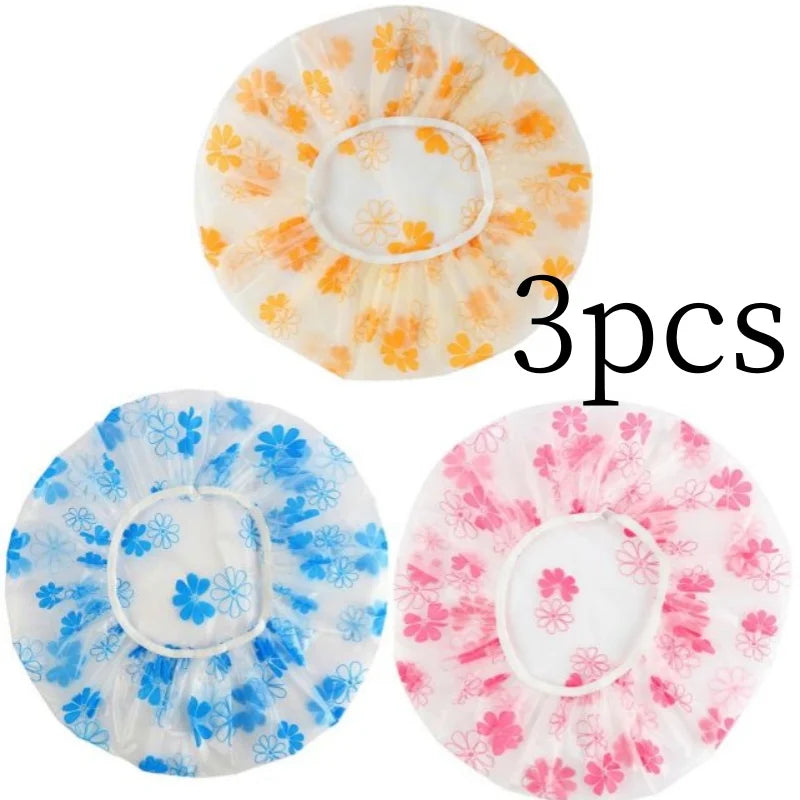 Three reusable polka dot waterproof shower caps in orange, blue, and pink floral patterns.