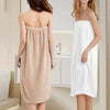 A woman models a white quick-dry wearable bathrobe towel in a studio setting.