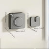 A silver retractable clothesline with a circular handle and storage mechanism mounted on a white wall.
