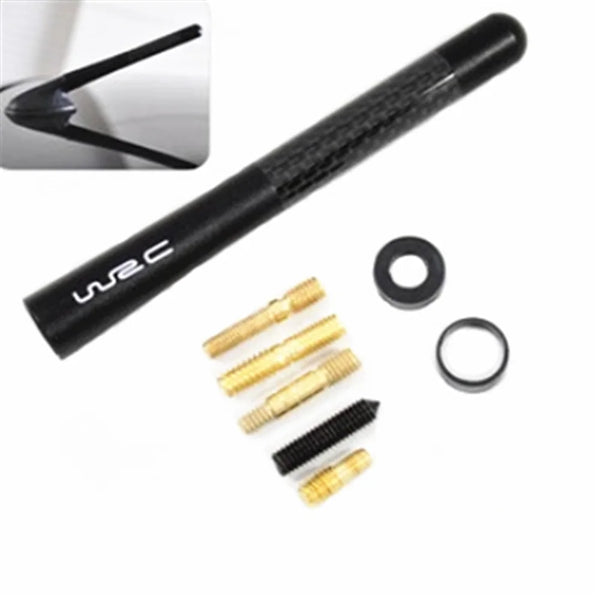 A black carbon fiber car radio antenna with various mounting hardware components.