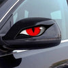 Close-up of a black car mirror featuring a red cat eye design.