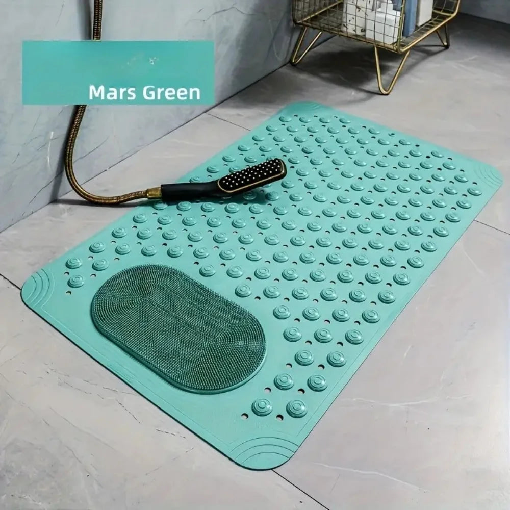 A teal non-slip bath mat with massage nodes and a small black tool is displayed on a light gray floor.