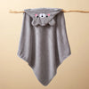 A gray hooded baby bathrobe towel with a cute bear face design hanging on a wooden stick.