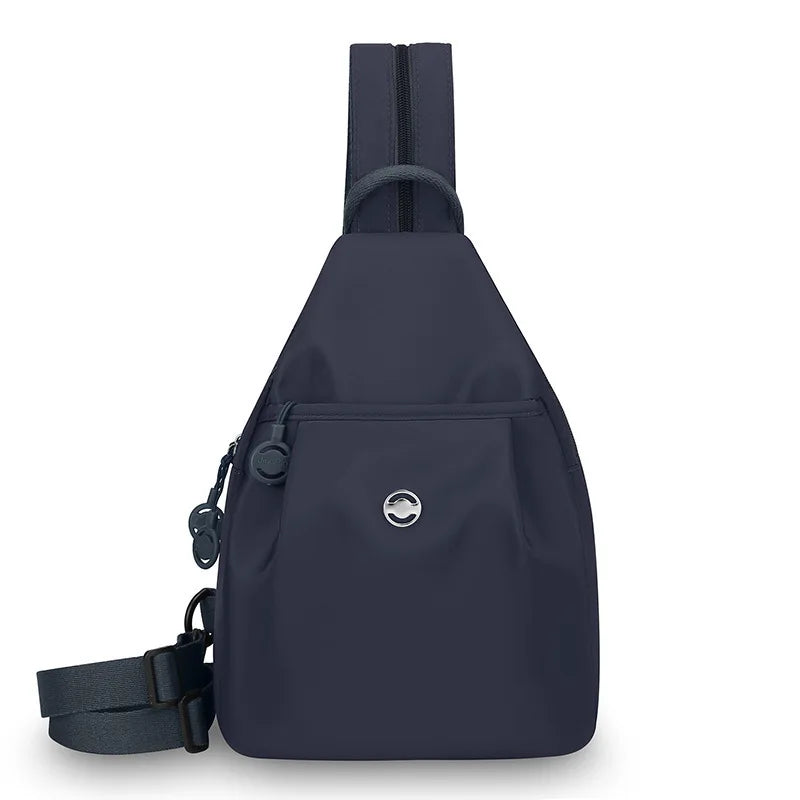 A navy blue women's lightweight mini backpack with a chest strap visible from the front.
