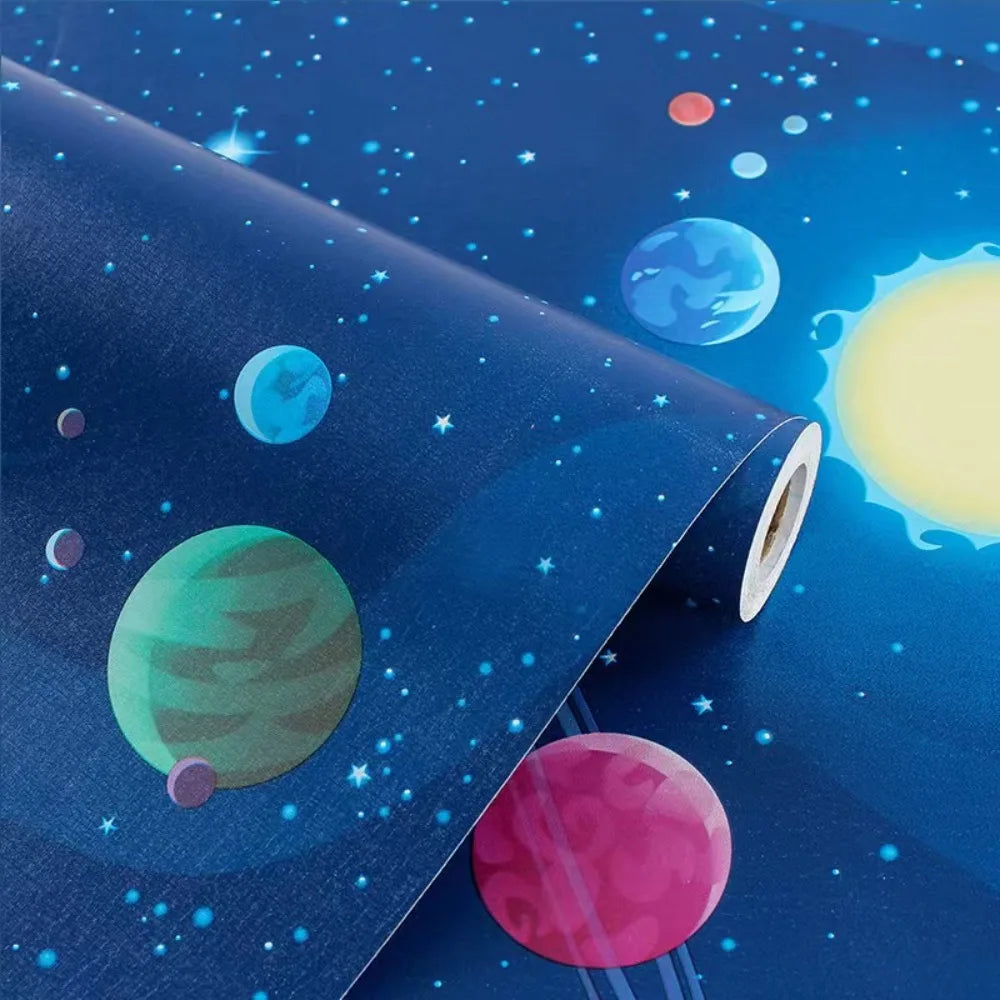 A roll of universe pattern peel-and-stick wallpaper featuring colorful planets and stars against a dark blue background.